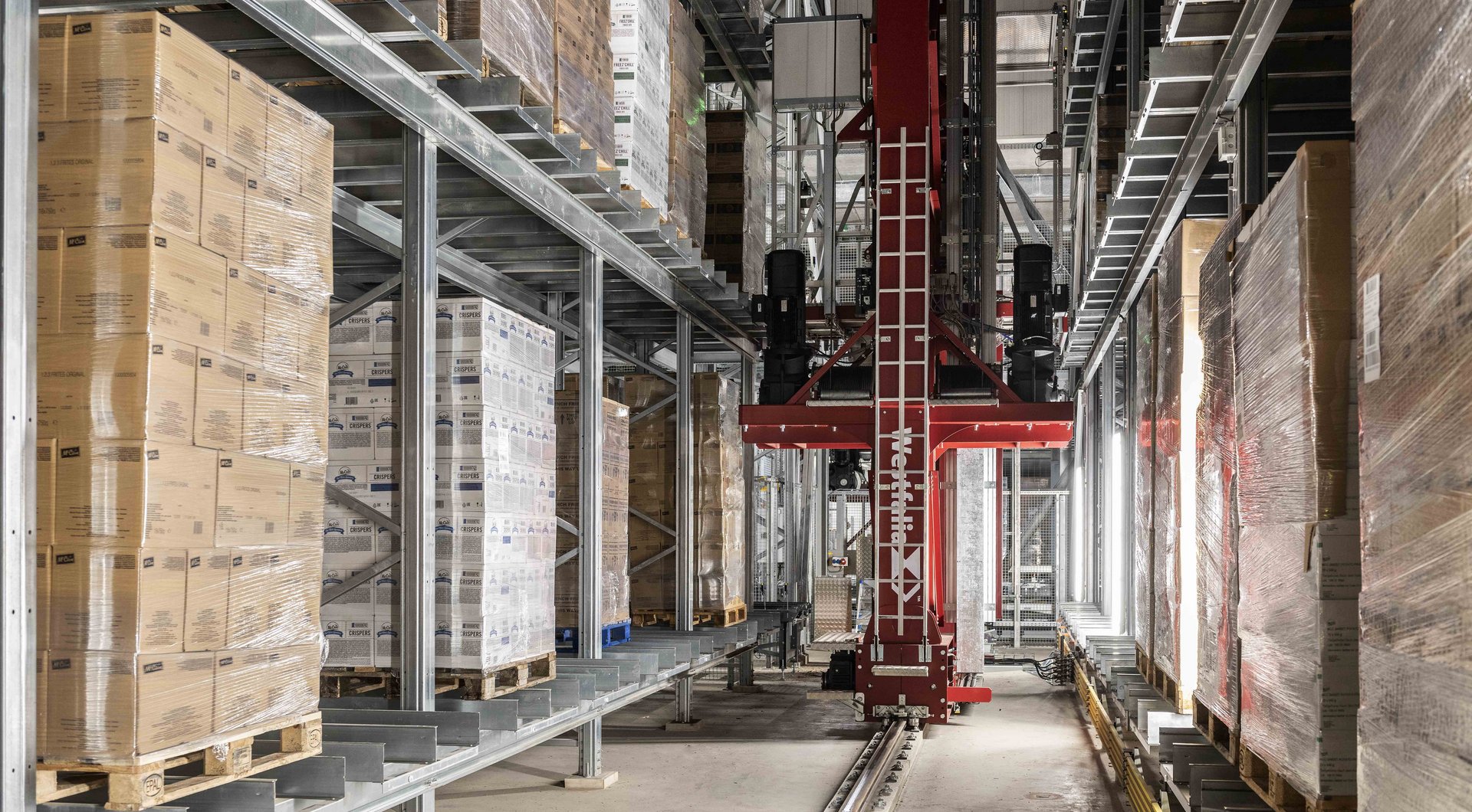 Automated high-bay warehouse, view of storage aisle and storage / retrieval machine 